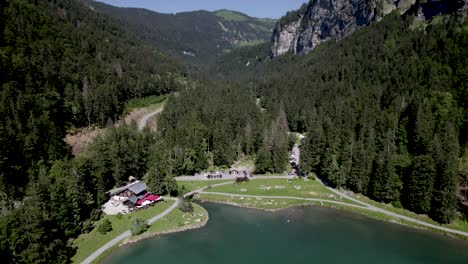 leisure beach at the montriond lake seen from above with scenic rising rock formations against a clear blue sky