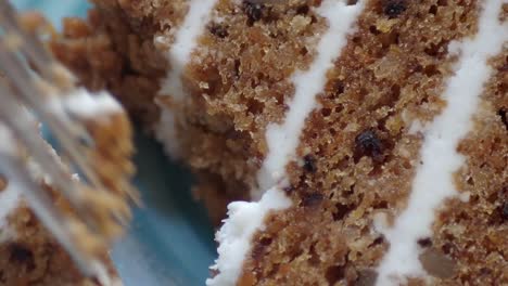 close-up of a slice of carrot cake with white frosting