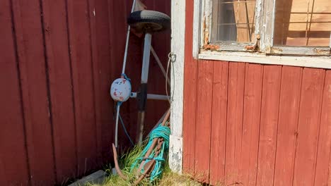 4K-60FPS-Fishing-Marker-Flags-and-an-Anchor-and-Rope-Right-Next-to-Old-Swedish-Fishing-Sheds---Tilt-Shot-and-Pan-Shot