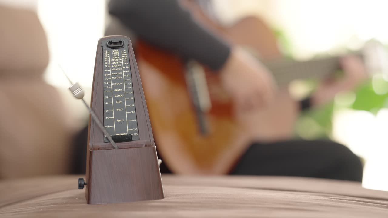Metronome ticking in harmony with acoustic guitar playing