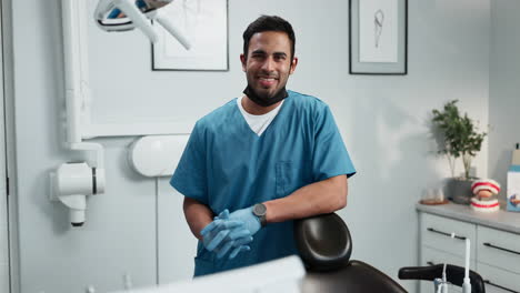 dentist smiling at the camera in a dental office