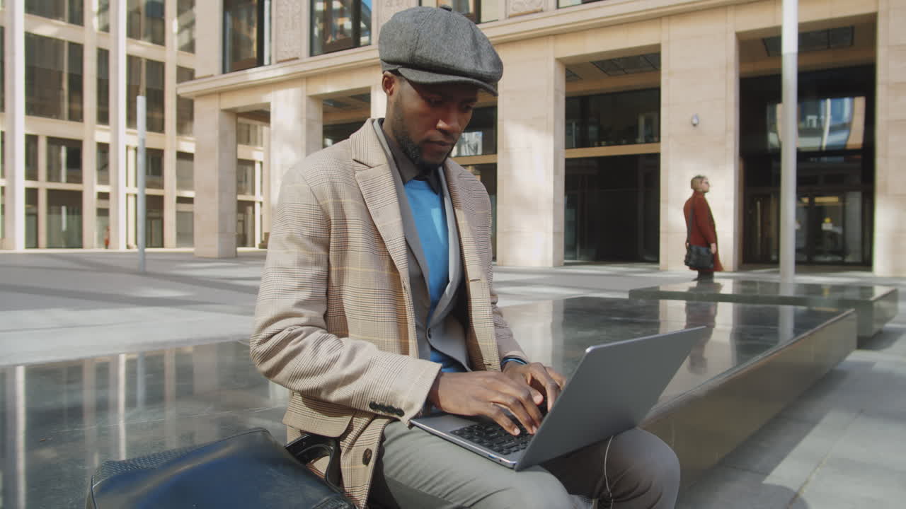 African American Businessman Using Laptop Outdoors