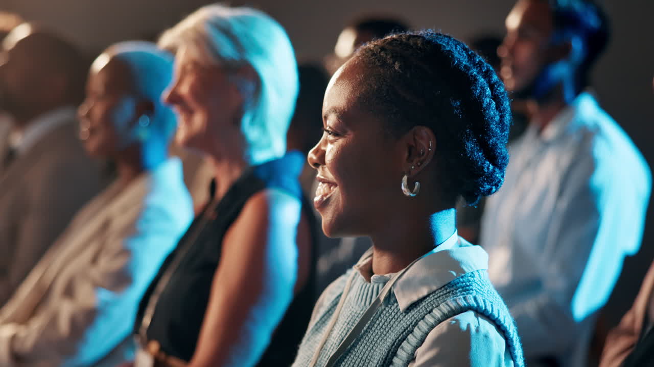 Smiling Woman in Audience Attending a Professional Conference