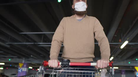 tilt up video of man walking on parking after shopping