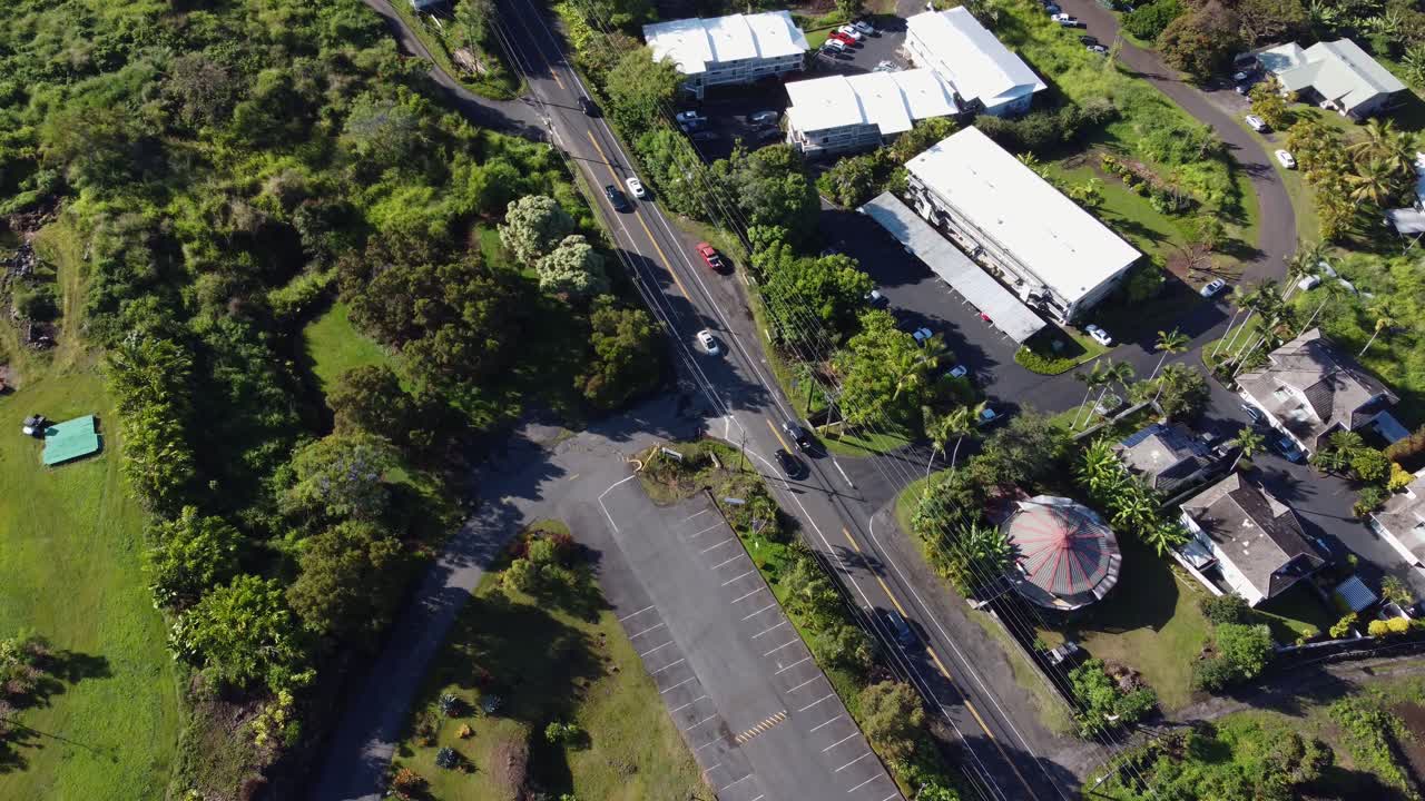 4K cinematic overhead drone shot of cars driving along a road near Kona on the Big Island of Hawaii
