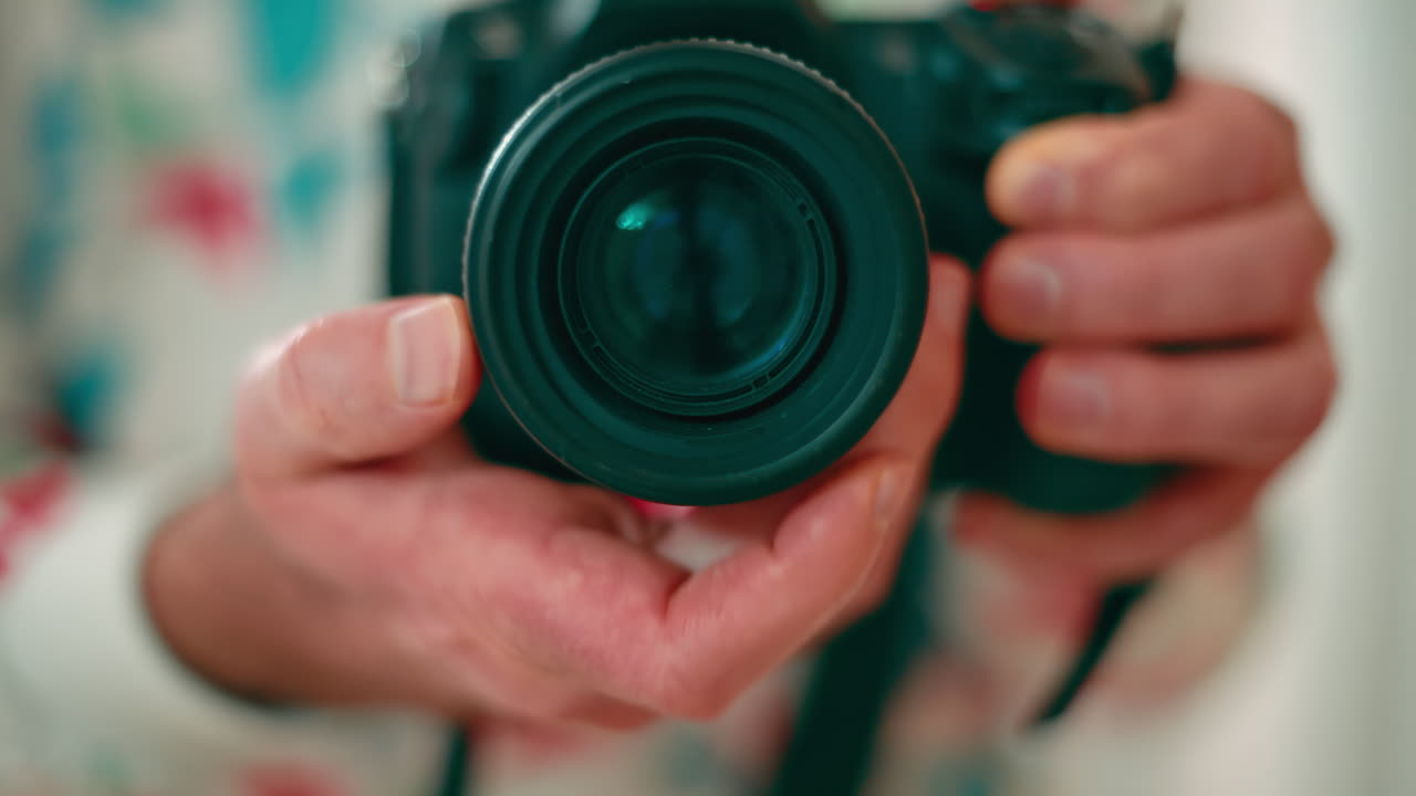 Man holding a camera shooting in the mirror. Rotating focus ring