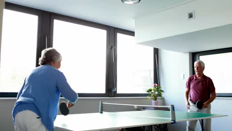 Senior-couple-playing-table-tennis