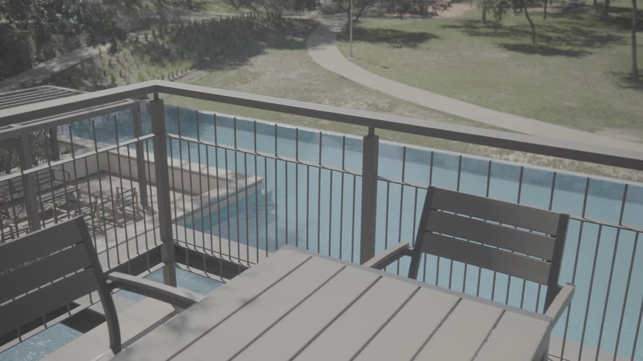Slow establishing shot of a private pool from a luxury villa balcony