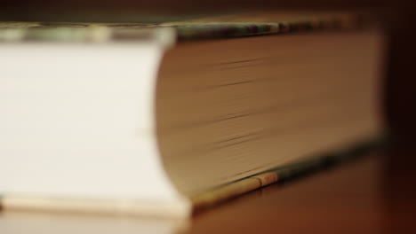 a book and its pages lying on a table, close up focus pull