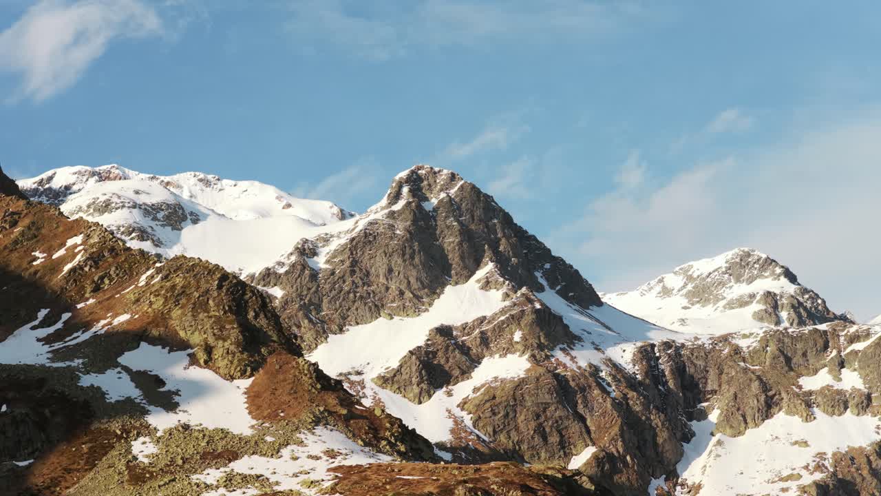 Scenic view of rugged, snow-covered mountains with a tranquil sky above.