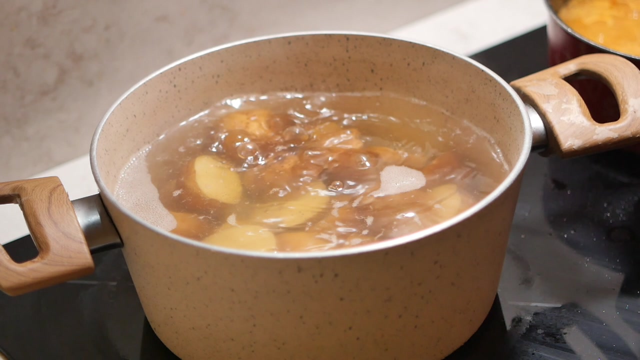 Potatoes Boiling in a Pot on a Kitchen Stovetop
