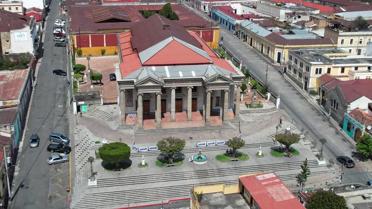 Teatro Municipal de Quetzaltenango. Drone footage of Municipal Theater of Quetzaltenango in urban colonial Central American city of Xela, Guatemala. Camera tracking left, panning right. Daylight.
