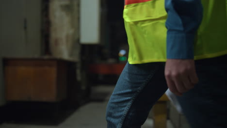 unrecognizable industrial engineer walking manufacturing company hold documents.