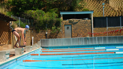 male swimmer getting ready for jump in swimming pool 4k