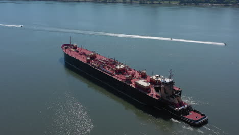 a drone view of a large red barge on the hudson river in ny