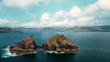 drone circling around rocky islands in the ocean in indonesia