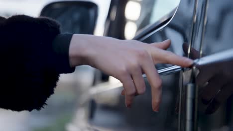 Woman-touches-car-with-fingers