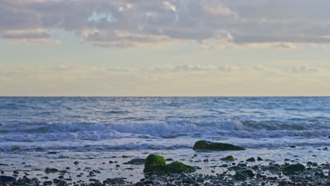 rocky beach during sunset with calming waves