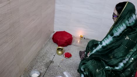 indian women doing holy rituals at home for children's wellbeing from different angle on the occasion of jitiya vrat or nirjala vrat in india