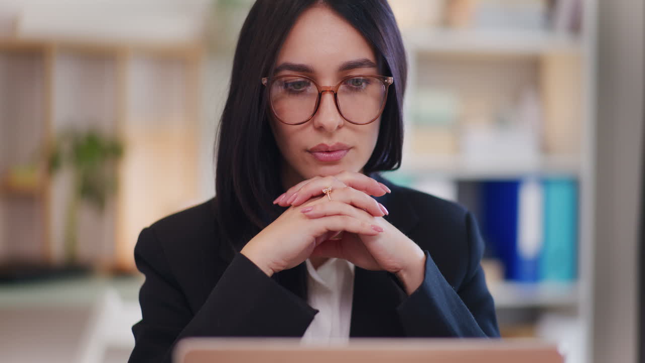 mujer segura leyendo correos electrónicos en la computadora portátil