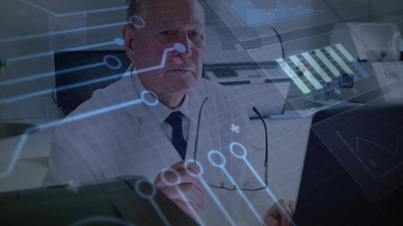 Senior male analyst typing on keyboard showing tech graphics and data charts pausing to analyze
