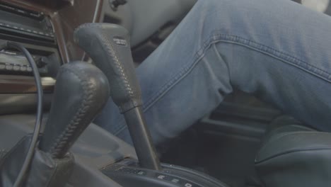 person shifting gears in a car