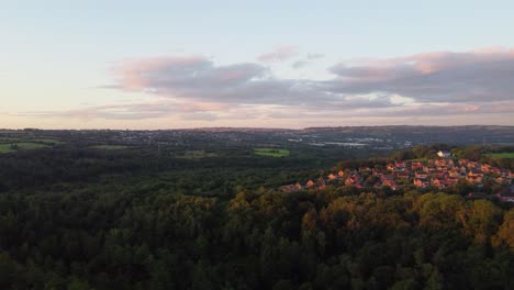 morning sunrise light over forest landscape with houses on hill top