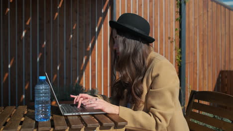 woman working on a laptop outdoors