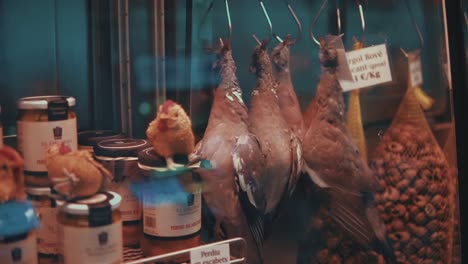 dead pigeons hanging for sale in a european style market