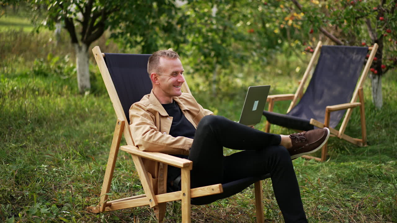 Man working on laptop in a garden