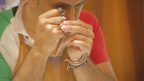 italian goldsmith at work building an engagement or a wedding ring