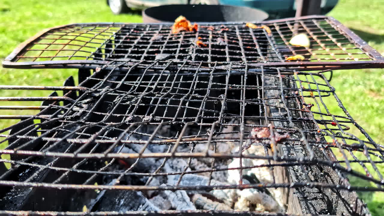 Dirty barbecue grill with burnt food and ash left after outdoor cooking