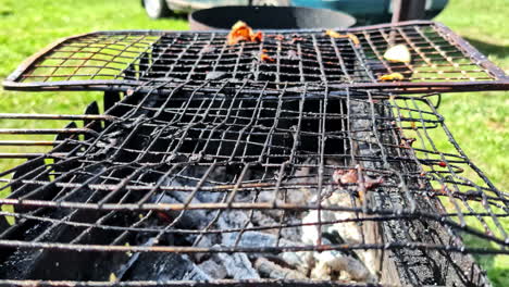 dirty barbecue grill with burnt food and ash left after outdoor cooking