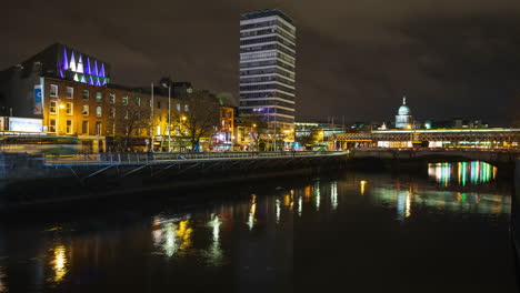 time lapse of nighttime road traffic and people walking by in dublin city centre along the liffey river in ireland