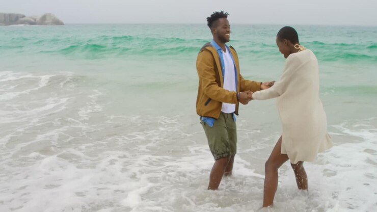 African american couple having fun together on the beach 4k