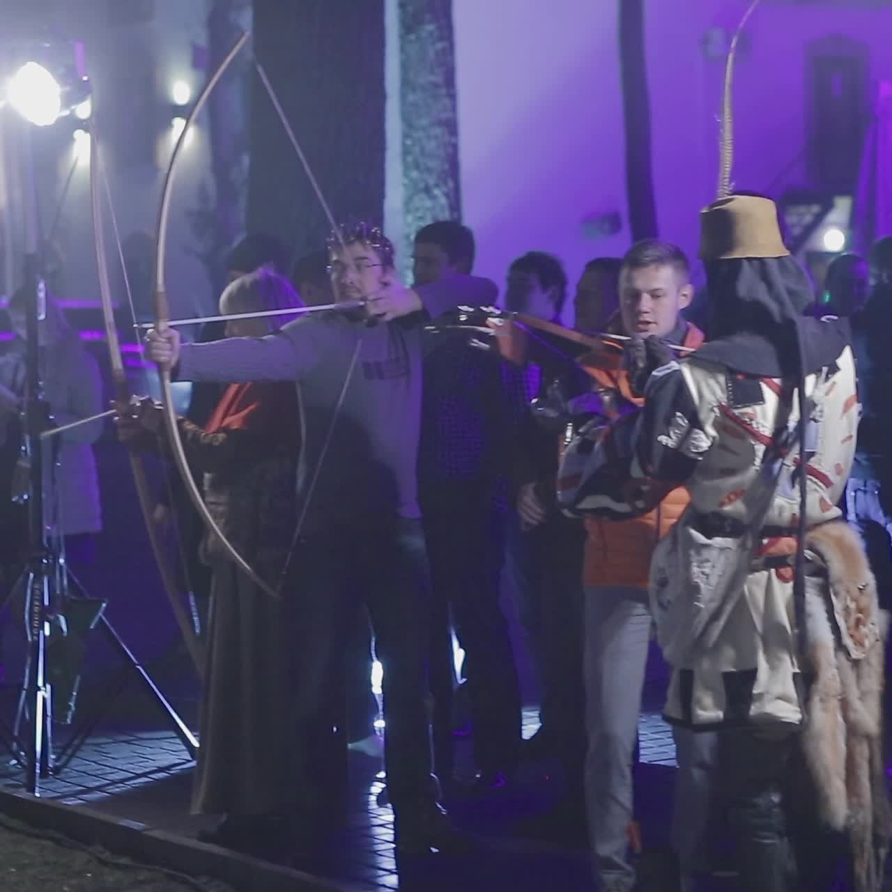 People Aims A Bow At A Target