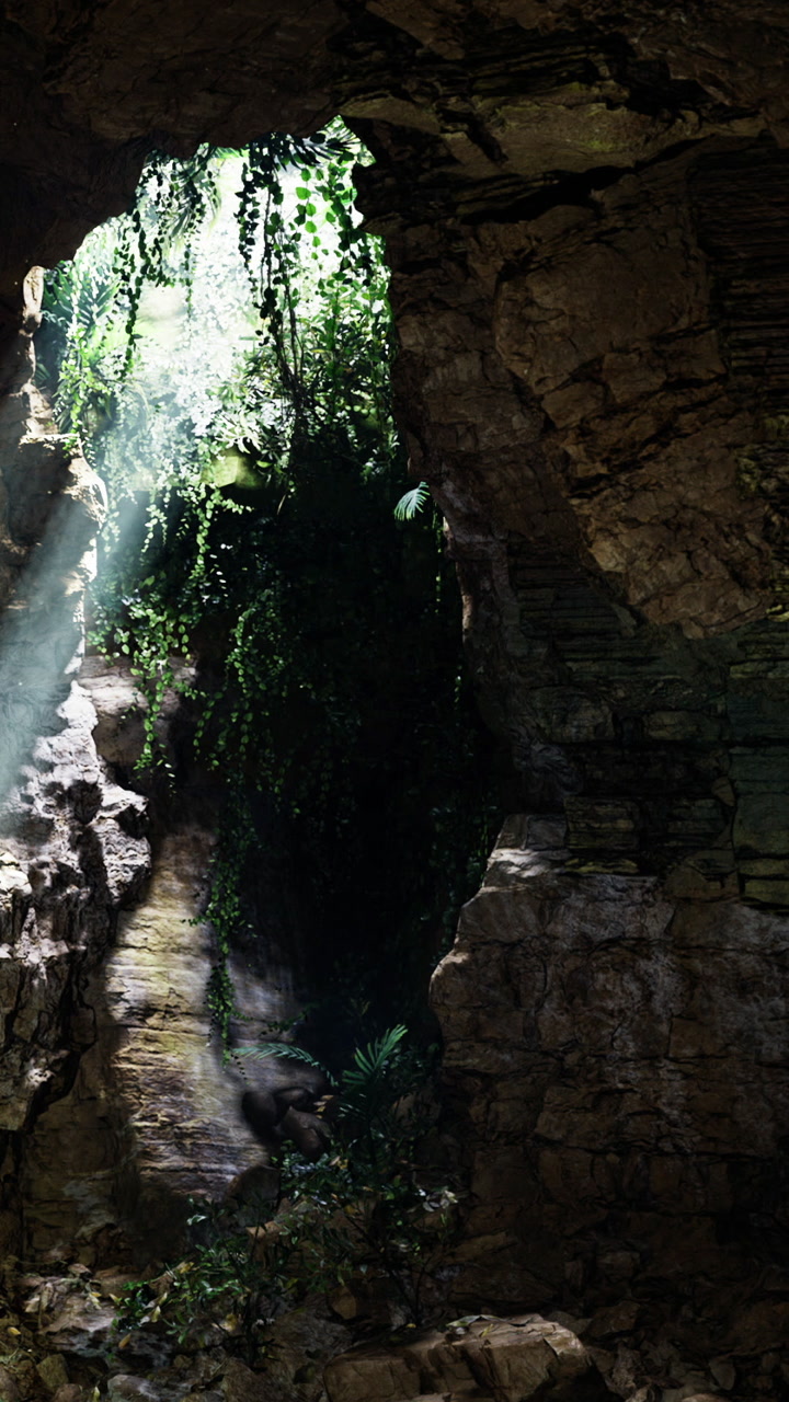 Bright light shines through cave opening in a rocky landscape