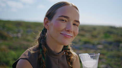 smiling woman milk mustache in sunlight closeup. happy farm model with braids