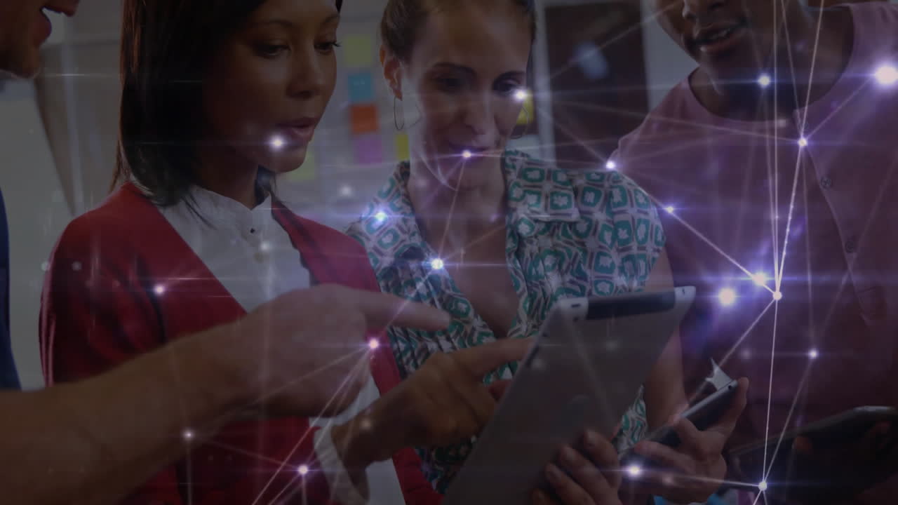 Business team collaborating around devices with sticky notes, featuring digital network overlay