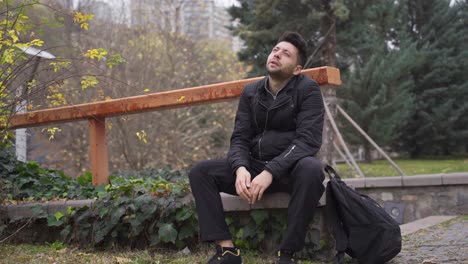 the sad man sitting outdoors, family problems, the concept of depression and suicide.