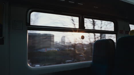 cinematic shot looking out window on train at sunrise