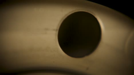 handheld camera capturing an close up of a metal object during its assembly