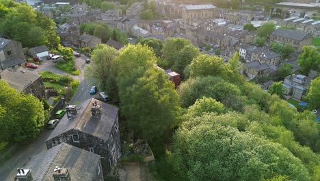 flying over the center of todmorden revealing the todmorden town hall , during golden hour on a sunny mid week evening