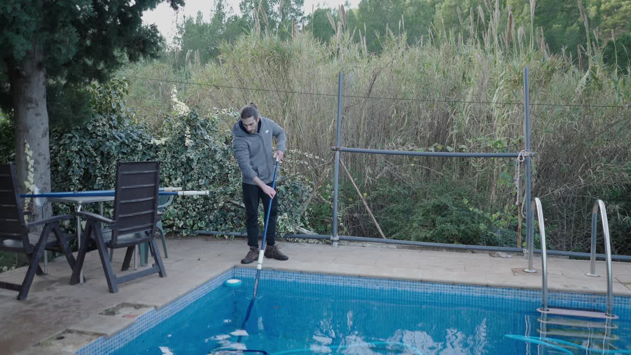 Man cleaning a swimming pool