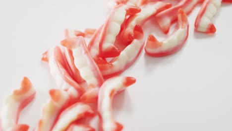 Close-up-view-of-halloween-sour-patch-candies-fallen-against-grey-background