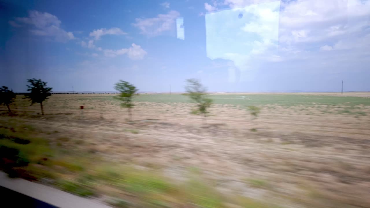 Train Journey Through a Dry and Flat Landscape
