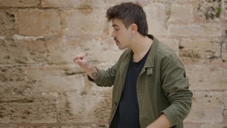 young man performing magic trick outdoors