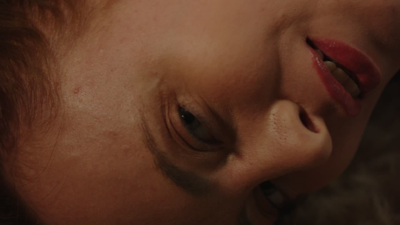 Beautiful macro of a sensual woman's eyes looking at the camera in slow motion