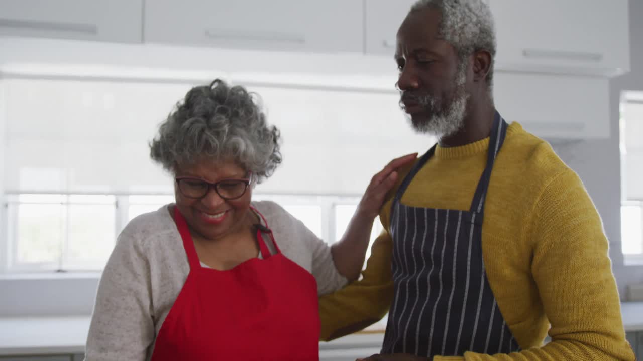 A senior African american couple cooking at home. Social distancing in quarantine