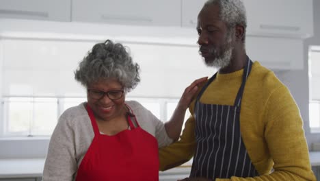 A-senior-African-american-couple-cooking-at-home.-Social-distancing-in-quarantine